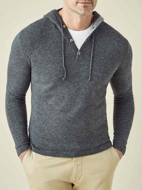 Front view of a man wearing the Stone Grey Cashmere Hoodie, featuring a three-button placket and styled over a t-shirt.