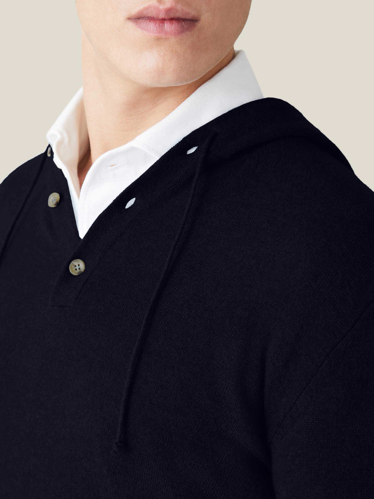 A close-up of the Luca Faloni Pure Cashmere Hoodie in midnight blue, focusing on the buttoned placket detail.