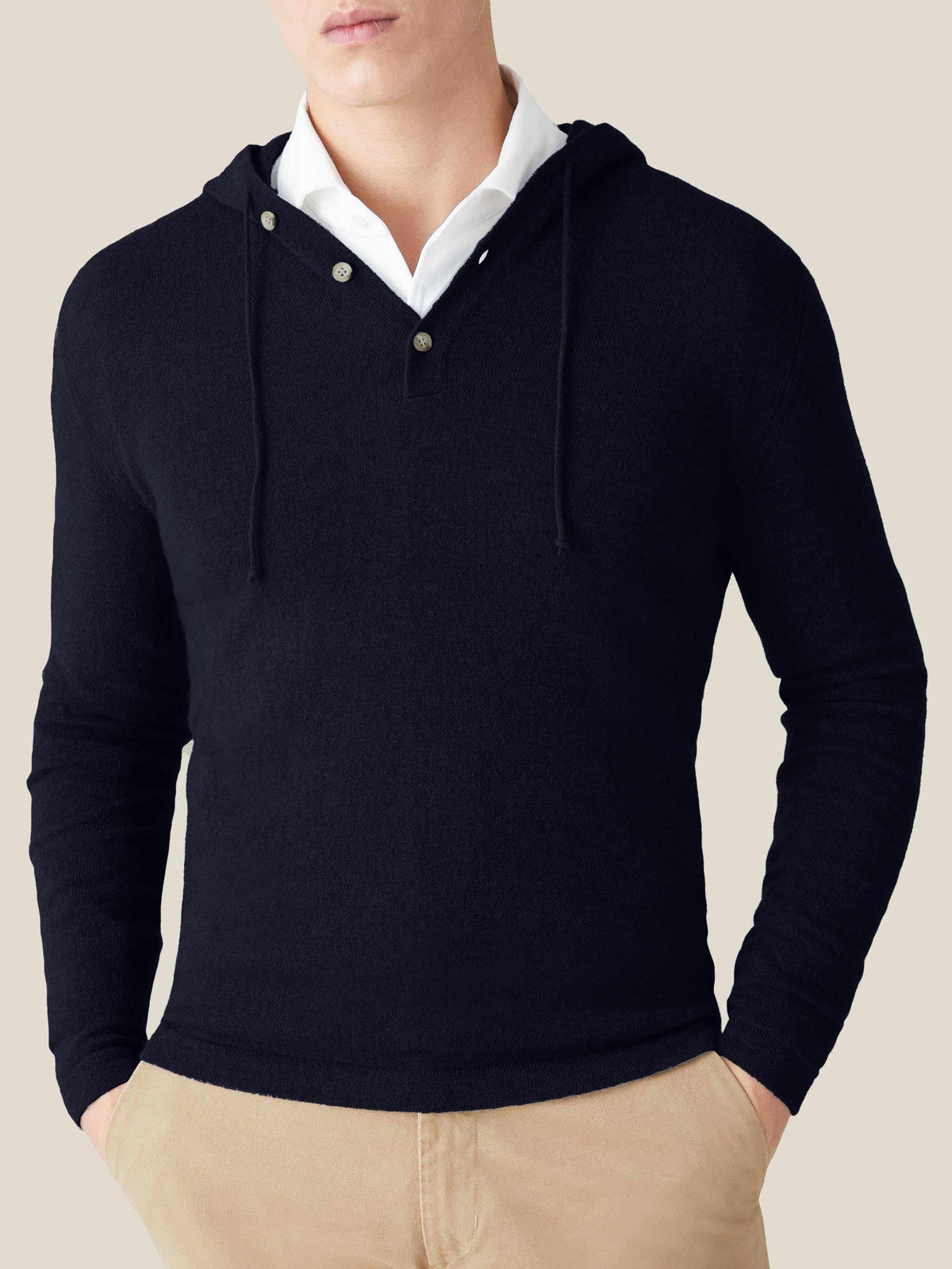 Front view of a man wearing the Midnight Blue Pure Cashmere Hoodie layered over a white shirt with beige chinos.