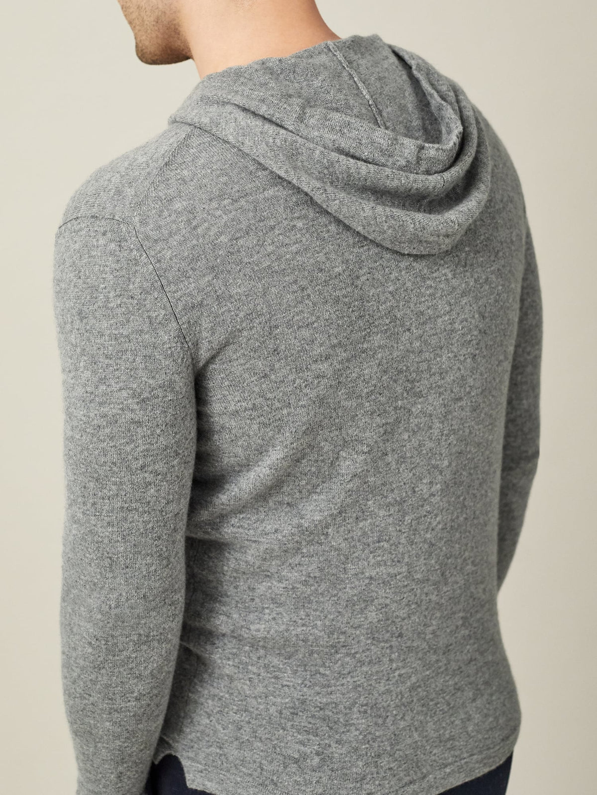 Back view of a model wearing the Dolomiti Grey cashmere hoodie, showing the fit and the detail of the hood.