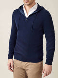 A model wears the Luca Faloni navy blue pure cashmere hoodie layered over a white shirt and paired with beige chinos.
