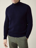 A model wears the Chunky Knit Mock Neck jumper in midnight blue, highlighting its ribbed texture and fit.
