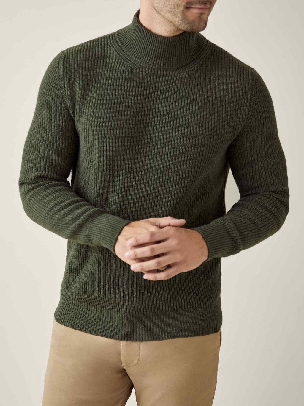 A model wears the Chunky Knit Mock Neck in Hunting Green, crafted from soft, ribbed four-ply cashmere.
