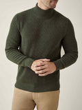 A model wears the Chunky Knit Mock Neck in Hunting Green, crafted from soft, ribbed four-ply cashmere.