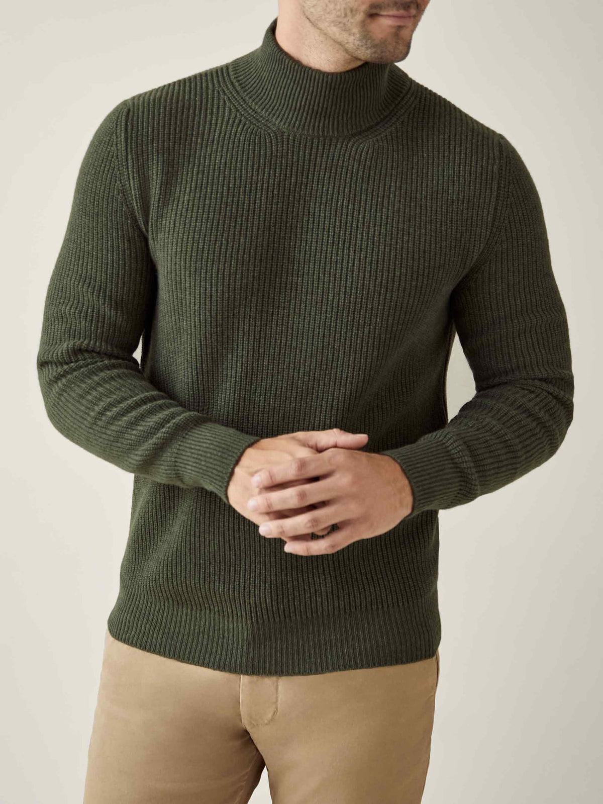 A model wears the Chunky Knit Mock Neck in Hunting Green, crafted from soft, ribbed four-ply cashmere.