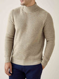 Front view of a model wearing the Luca Faloni Chunky Knit Mock Neck in Camel Beige with navy trousers.