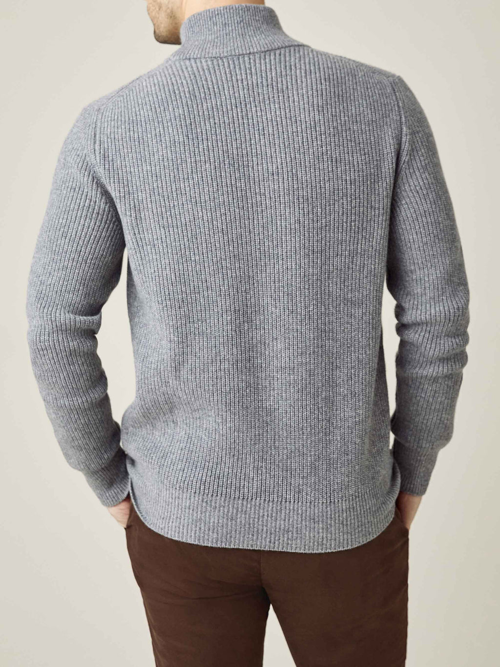 Back view of a man wearing the Dolomiti Grey Chunky Knit Cashmere Mock Neck, showing the ribbed texture and relaxed fit.