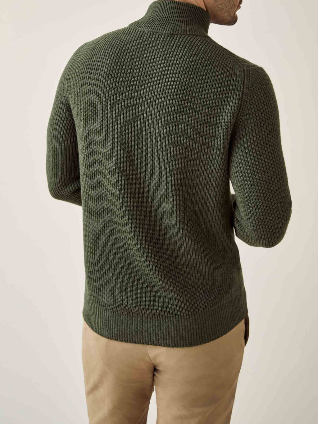 Back view of a model wearing the Chunky Knit Mock Neck in Hunting Green, showing the ribbed texture and relaxed fit.
