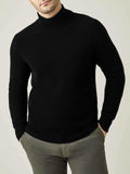 Front view of a model wearing the Luca Faloni Black Chunky Knit Cashmere Mock Neck with grey trousers.
