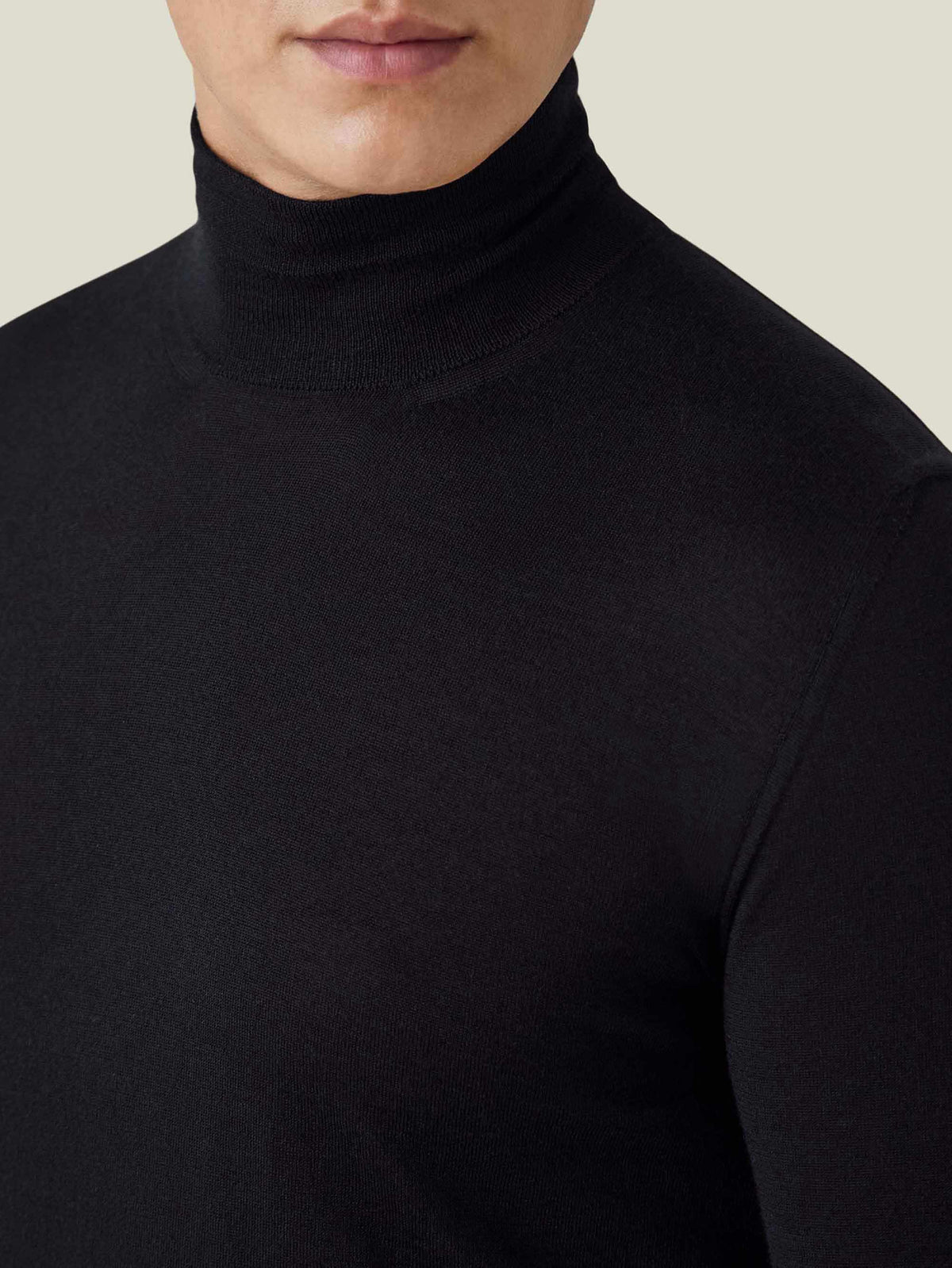 Close-up of the black silk-cashmere mock neck, showing the ribbed neckline and fine knit detail on a model.