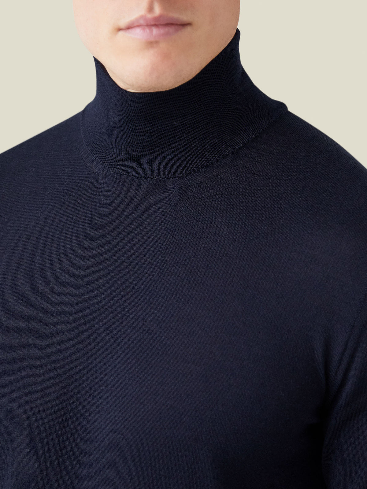 Close-up detail of the fine-gauge knit and neckline of the Luca Faloni Silk-Cashmere Mock Neck in Navy Blue.