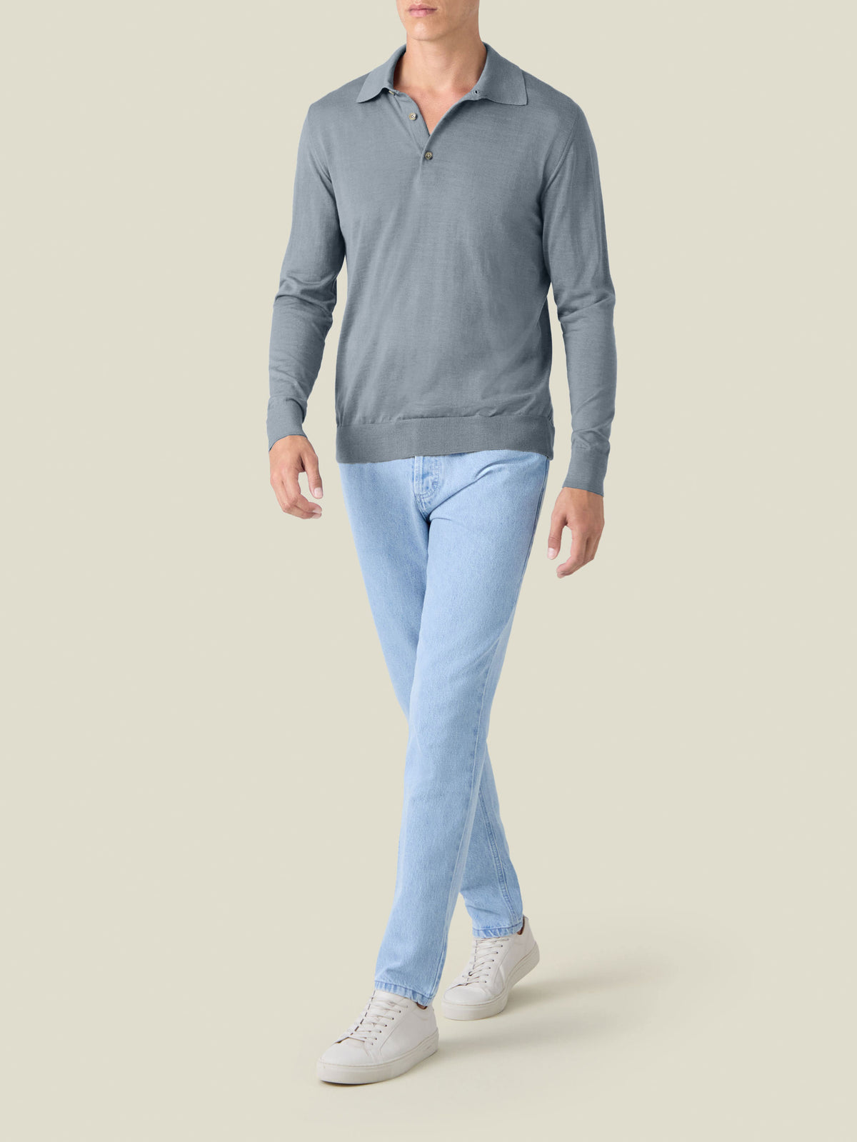 A model wears the Fine Silk Cashmere Polo in French Blue, styled with light wash jeans and white sneakers. Front view.