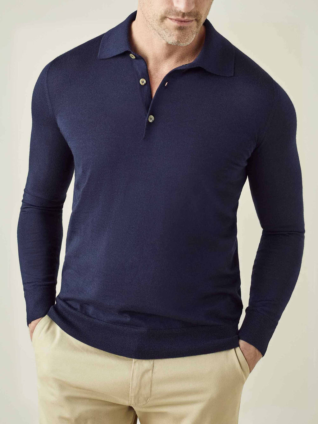 Front view of a model wearing the Luca Faloni Fine Silk Cashmere Polo in navy blue with beige trousers.