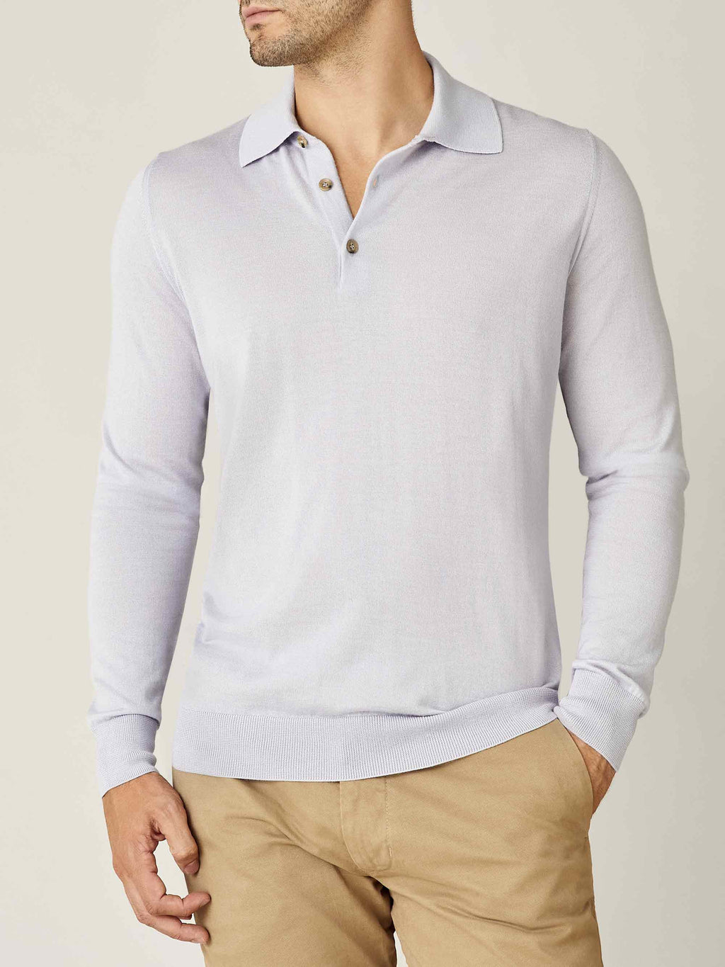 Front view of a model wearing the Luca Faloni Fine Silk Cashmere Polo in Ice Grey, paired with beige chinos.