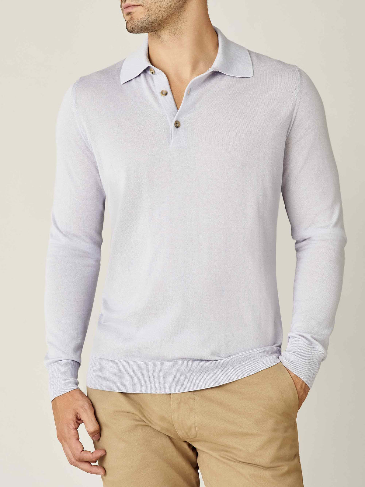 Front view of a model wearing the Luca Faloni Fine Silk Cashmere Polo in Ice Grey, paired with beige chinos.