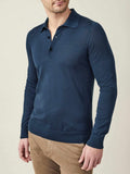 Front view of a model wearing the long-sleeved Fine Silk Cashmere Polo in Atlantic Blue, paired with tan chinos.