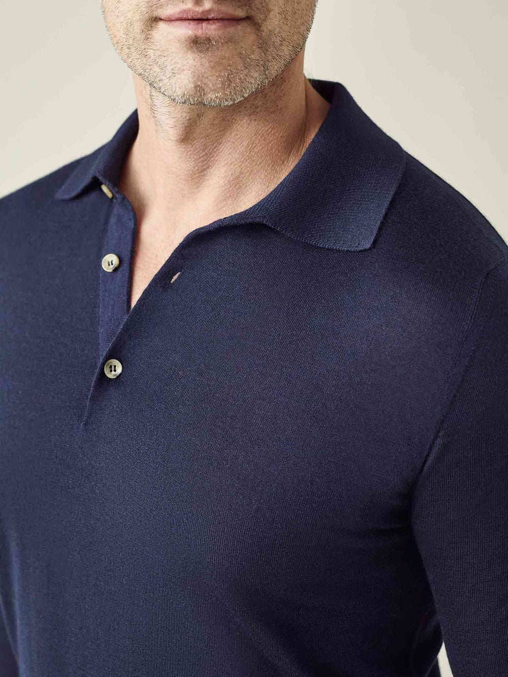Close-up of a man wearing the Navy Blue Fine Silk Cashmere Polo, showing the spread collar, buttons, and fine knit texture.