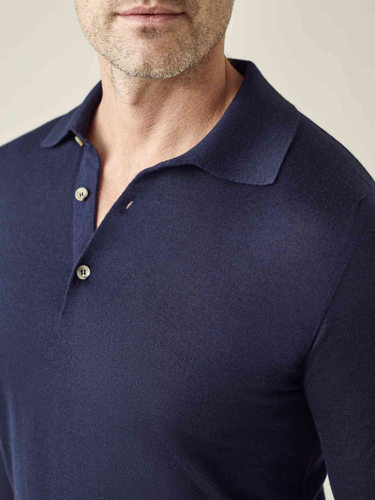 Close-up of a man wearing the Navy Blue Fine Silk Cashmere Polo, showing the spread collar, buttons, and fine knit texture.