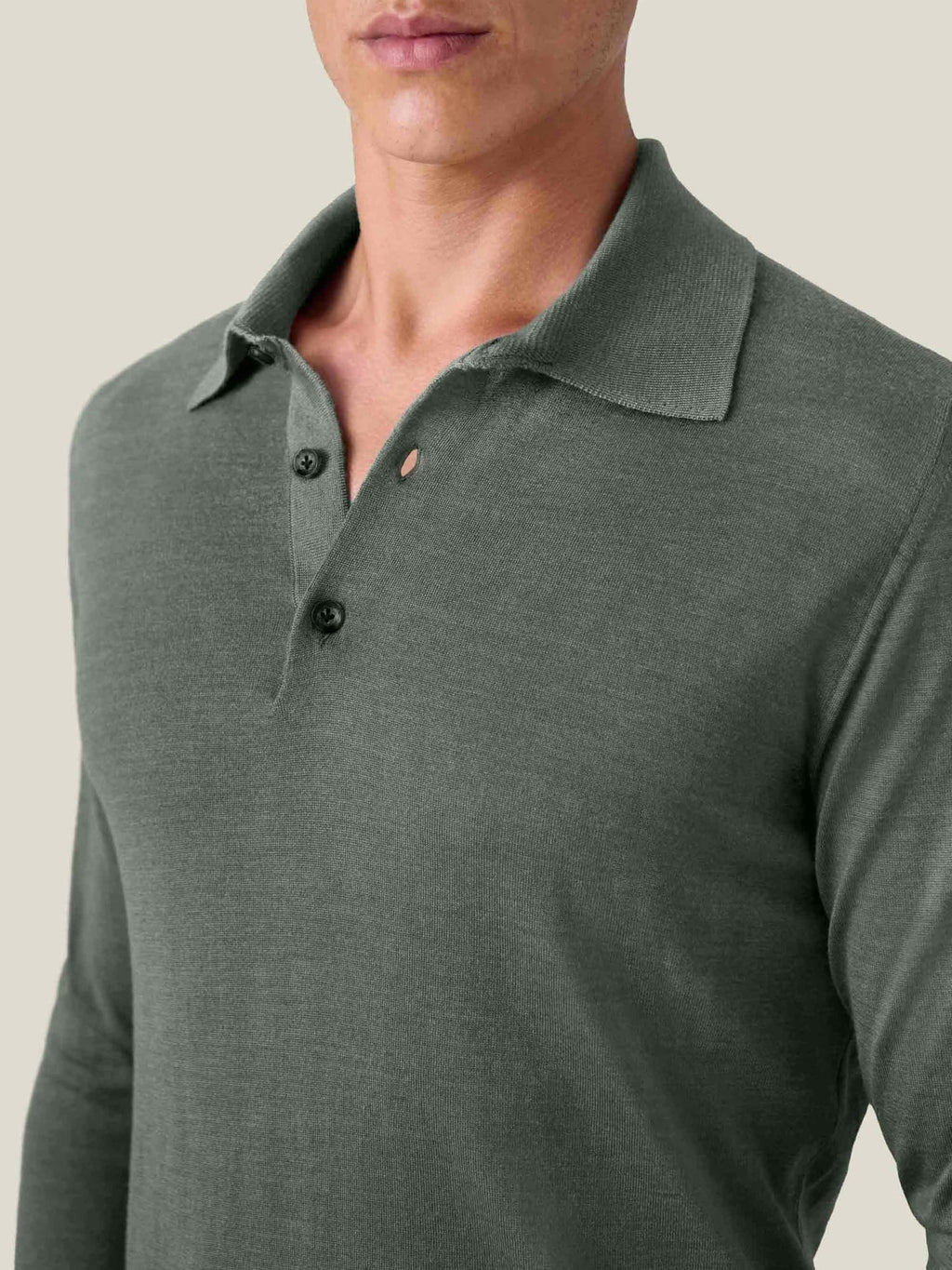 Close-up of a model wearing the Moss Green Fine Silk Cashmere Polo, showcasing the spread collar and fine knit texture.