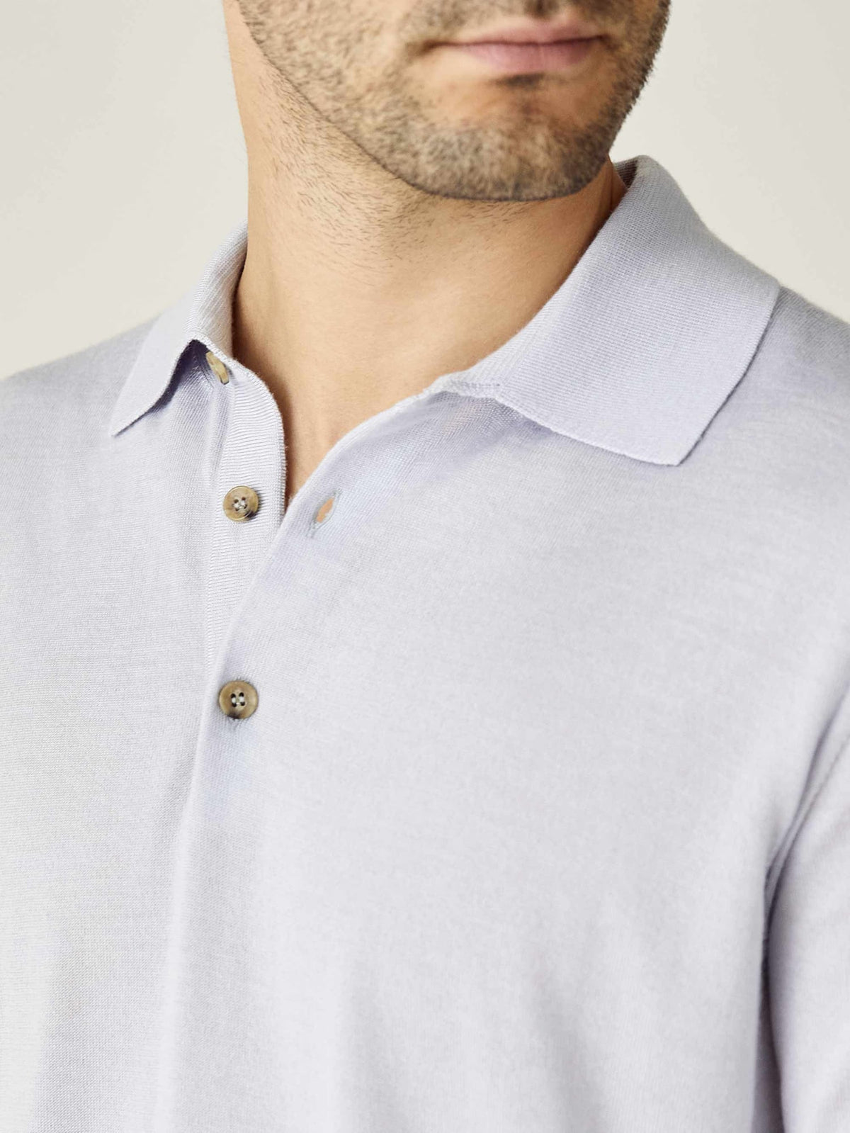 Close-up of the Luca Faloni Fine Silk Cashmere Polo in Ice Grey, highlighting the spread collar and three horn buttons.