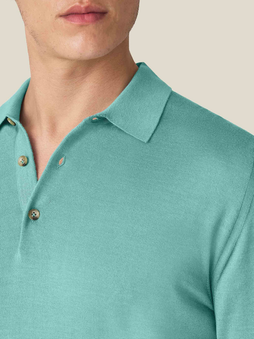 A close-up of the Aquamarine Fine Silk Cashmere Polo showing the detailed spread collar and horn buttons.