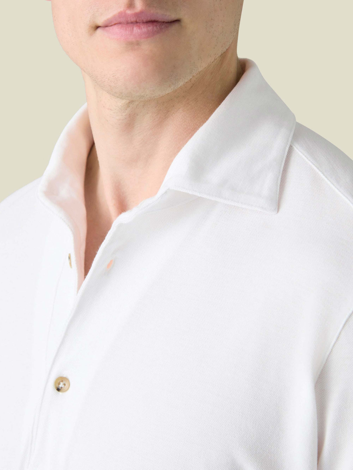 Close-up of the collar and mother-of-pearl buttons on the white Brera Piqué Polo Shirt.