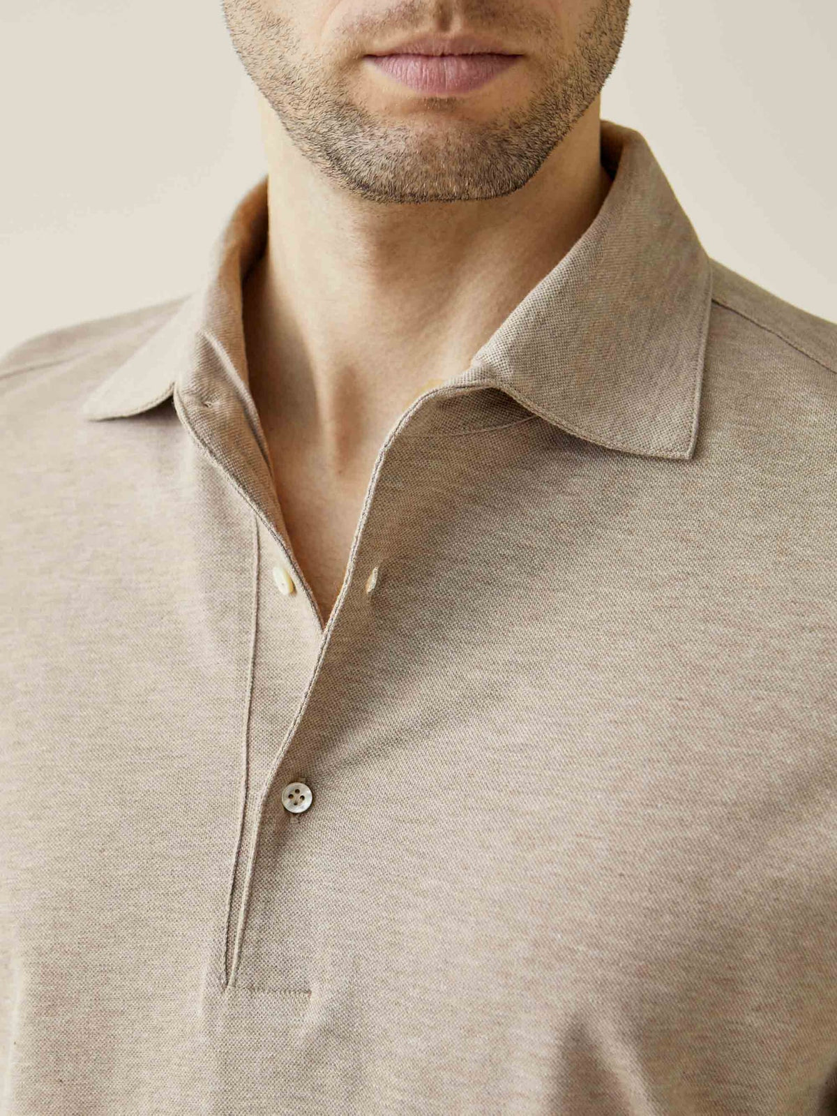 Detail of the Brera Piqué Polo Shirt in oatmeal, highlighting the signature one-piece collar and textured cotton fabric.