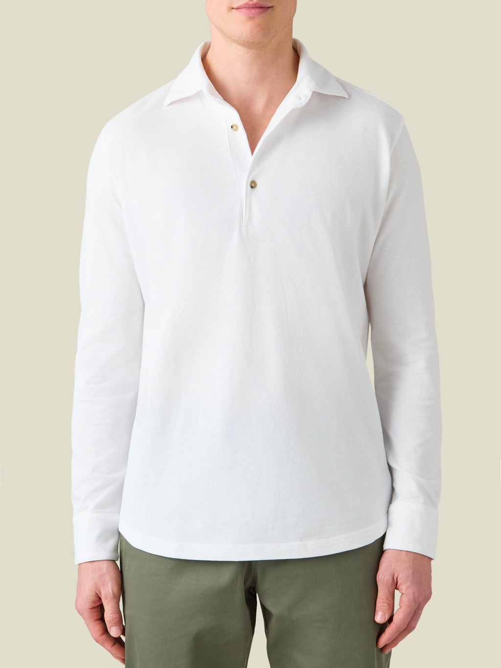 Front view of a model wearing the Brera Piqué Polo Shirt in white.
