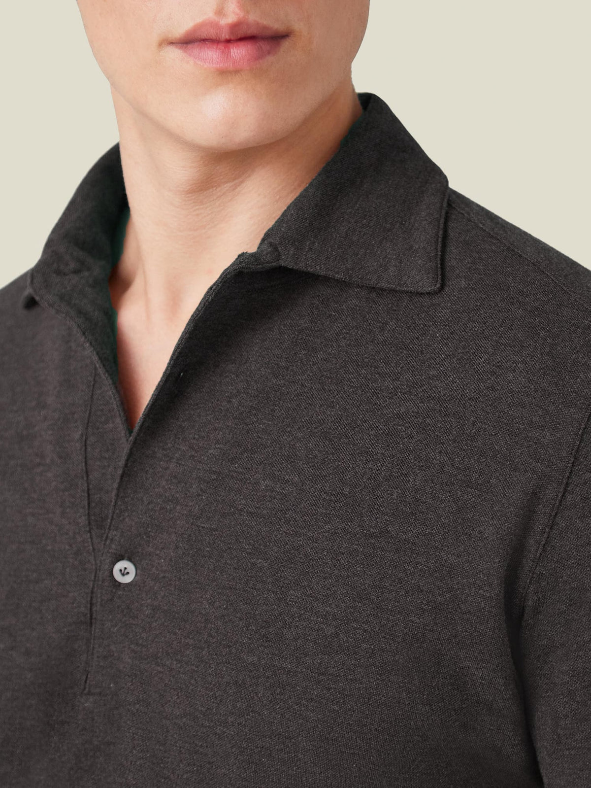 A close-up of the Brera Piqué Polo Shirt in Charcoal Grey, highlighting the soft cotton piqué fabric and one-piece collar.