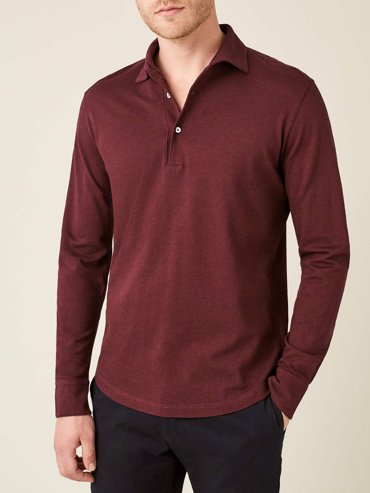 A model wears the long-sleeved Brera Piqué Polo Shirt in Lava Red, shown from the front against a neutral background.