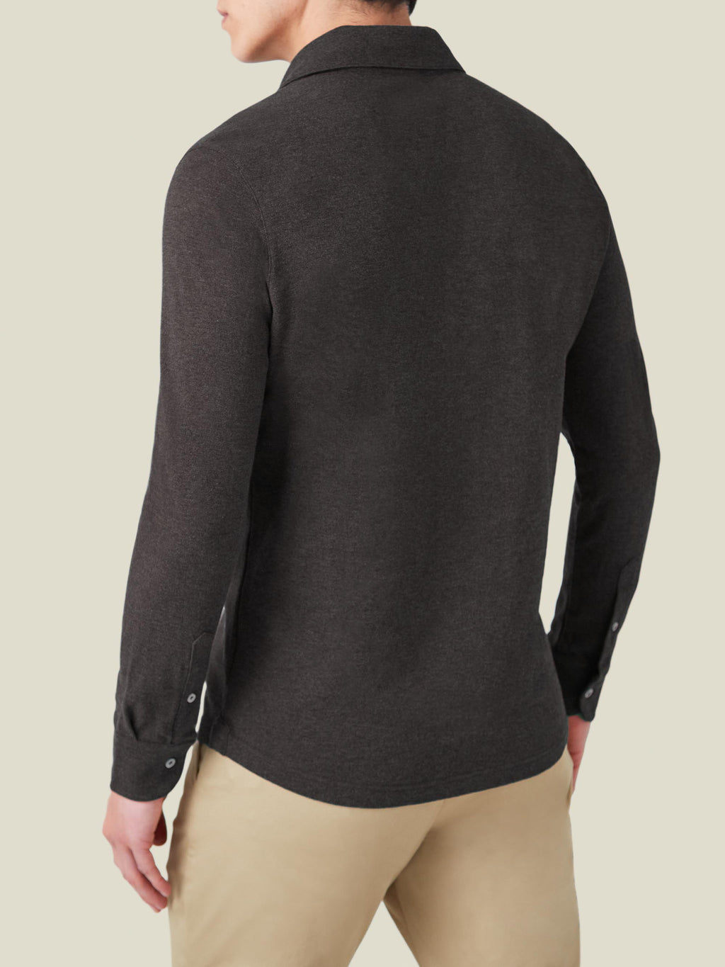 Back view of a man wearing the long-sleeved Brera Piqué Polo Shirt in Charcoal Grey, showing the fit and details.
