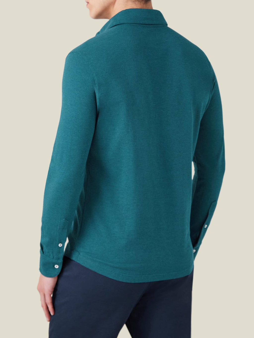Back view of a model wearing the long-sleeved Brera Piqué Polo Shirt in Forest Green.