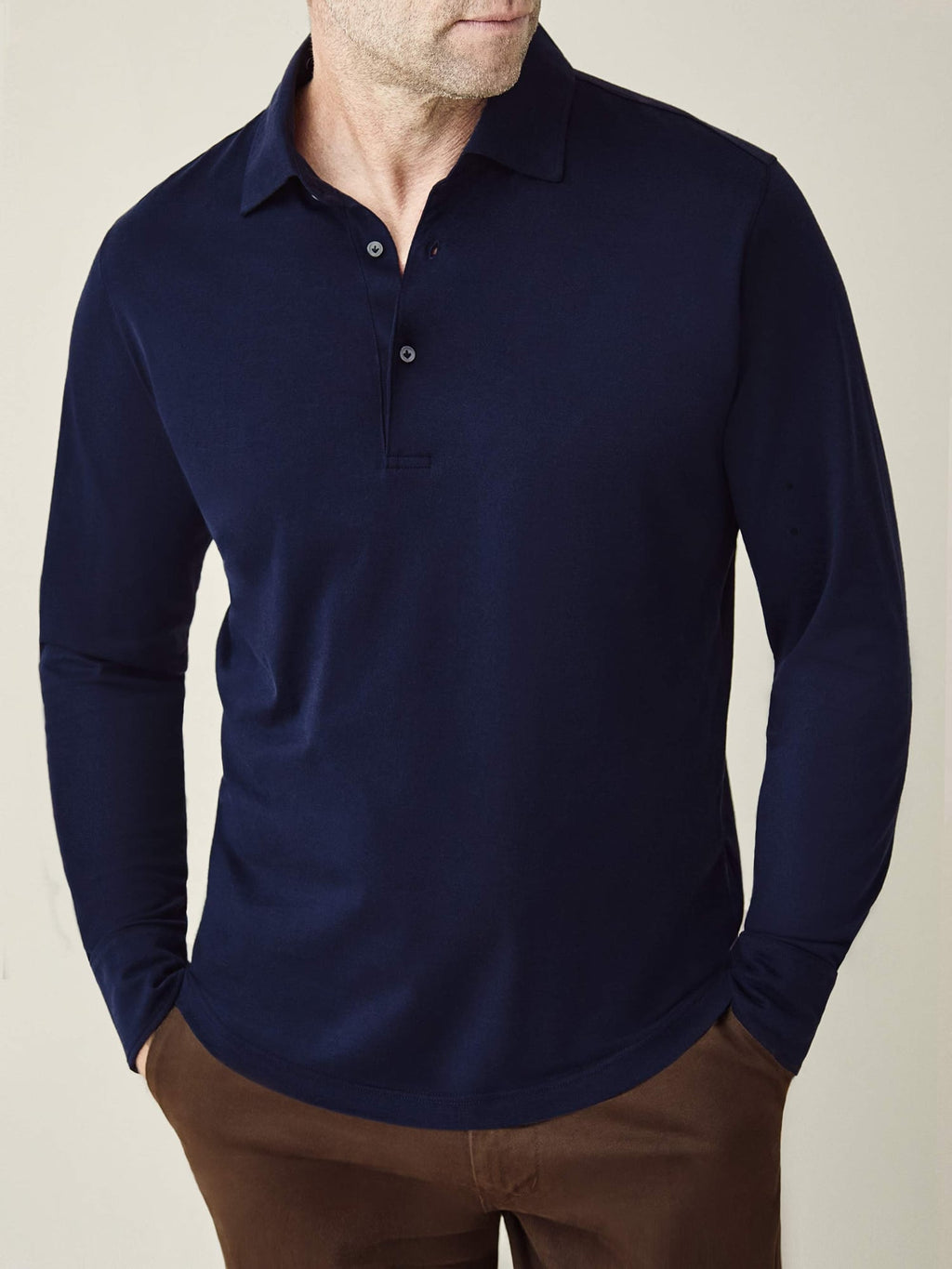 Front view of a model wearing the long-sleeved Amalfi Silk-Cotton Polo Shirt in Midnight Blue.