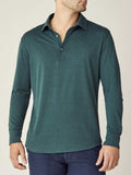 Front view of a model wearing the long-sleeved Amalfi Silk-Cotton Polo Shirt in Emerald Green.