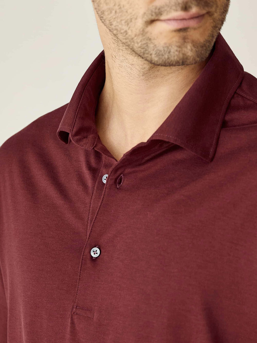 Close-up on the collar and mother-of-pearl buttons of the lava red Amalfi Silk-Cotton Polo Shirt.