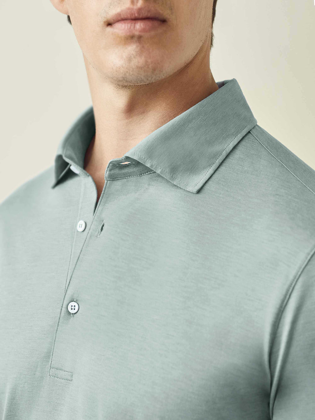 Close-up of the Marine Green Amalfi Silk-Cotton Polo Shirt, focusing on the collar, button placket, and fabric texture.