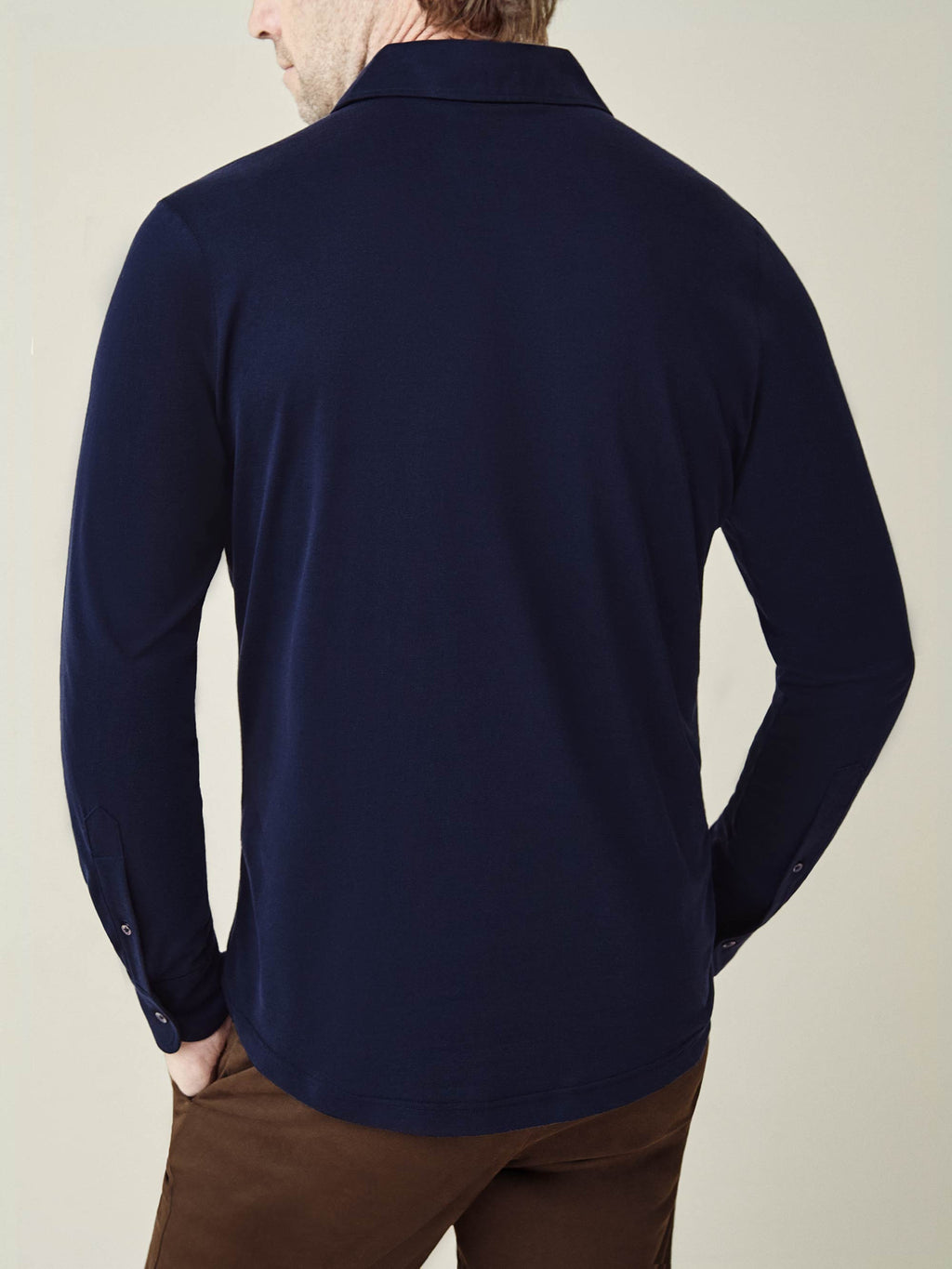 Back view of a man wearing the Amalfi Silk-Cotton Polo Shirt in Midnight Blue.