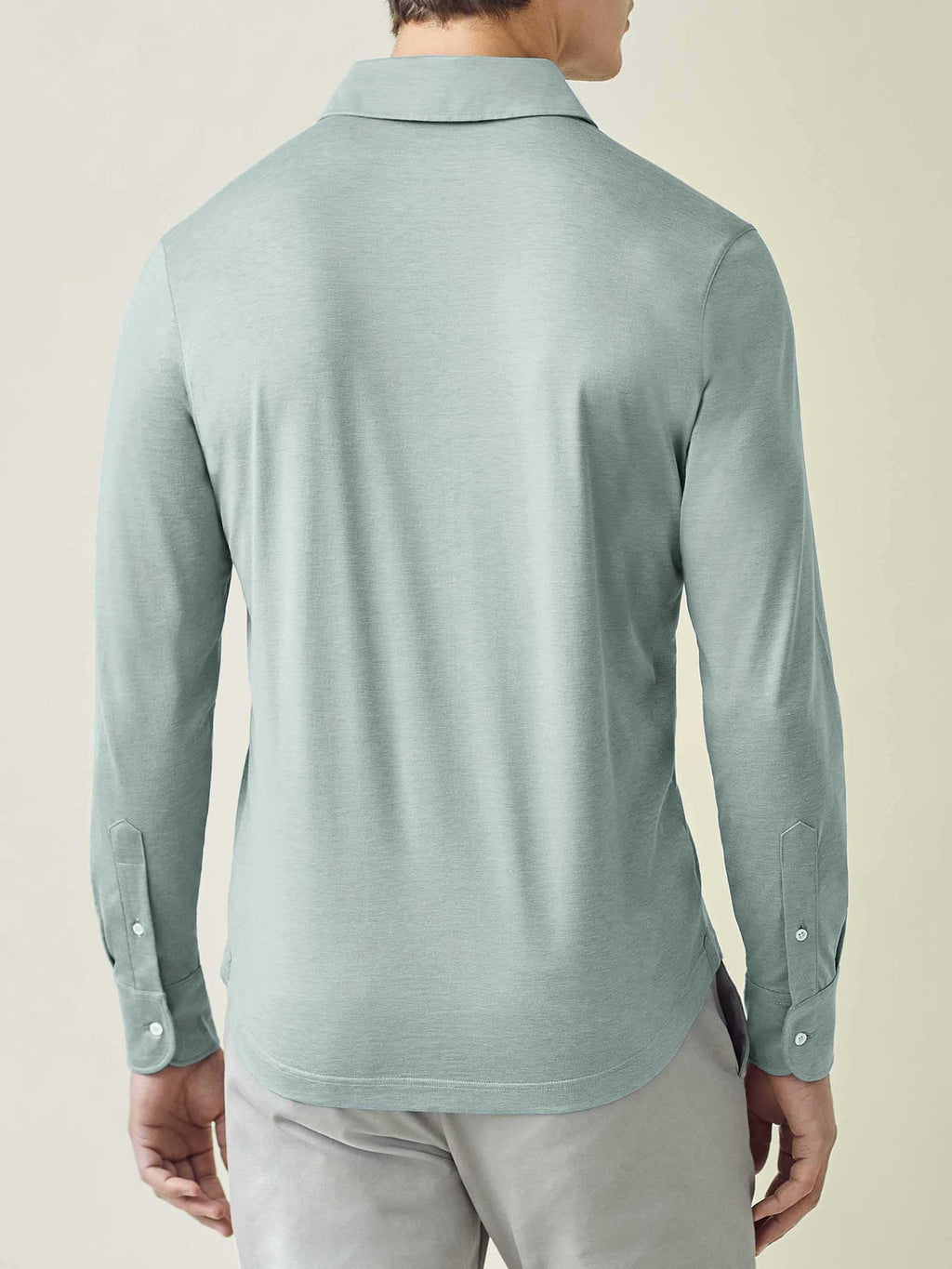 Back view of the Amalfi Silk-Cotton Polo Shirt in Marine Green, showcasing the slim fit and shirt-style cuffed sleeves.