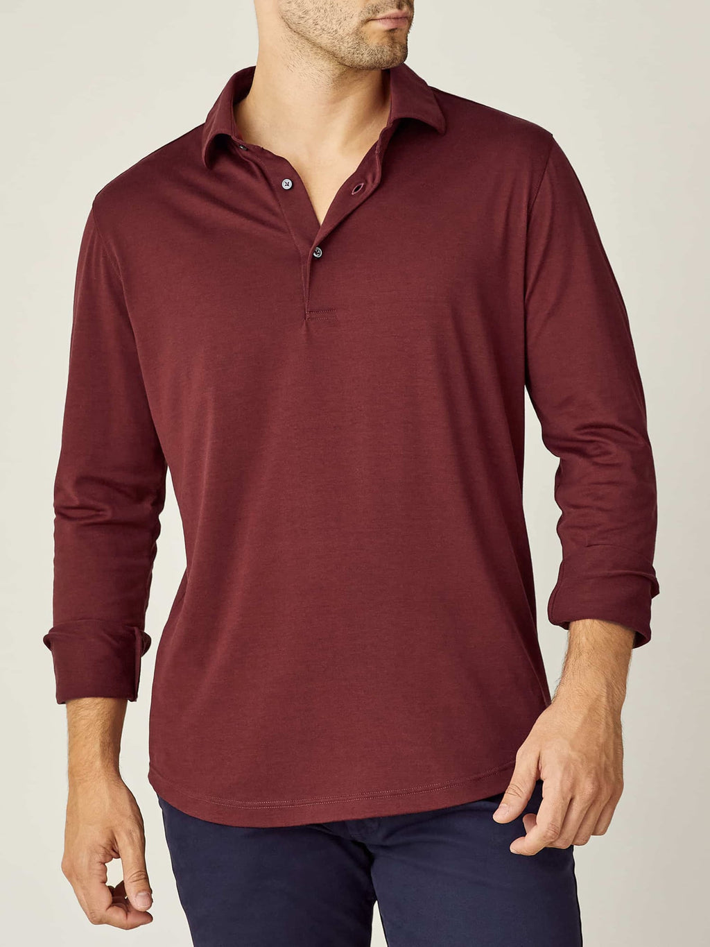 Front view of a model wearing the Amalfi Silk-Cotton Polo Shirt in Lava Red with sleeves rolled up.