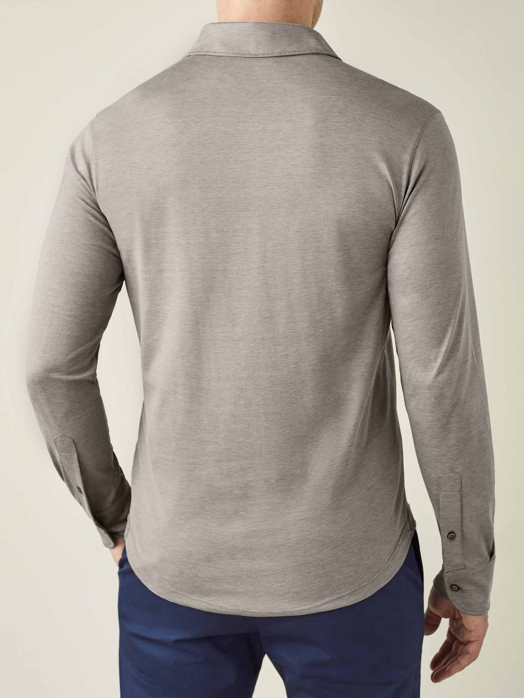 Back view of a model wearing the Amalfi Silk-Cotton Polo Shirt in Nocciola Brown, showing the collar and fit.