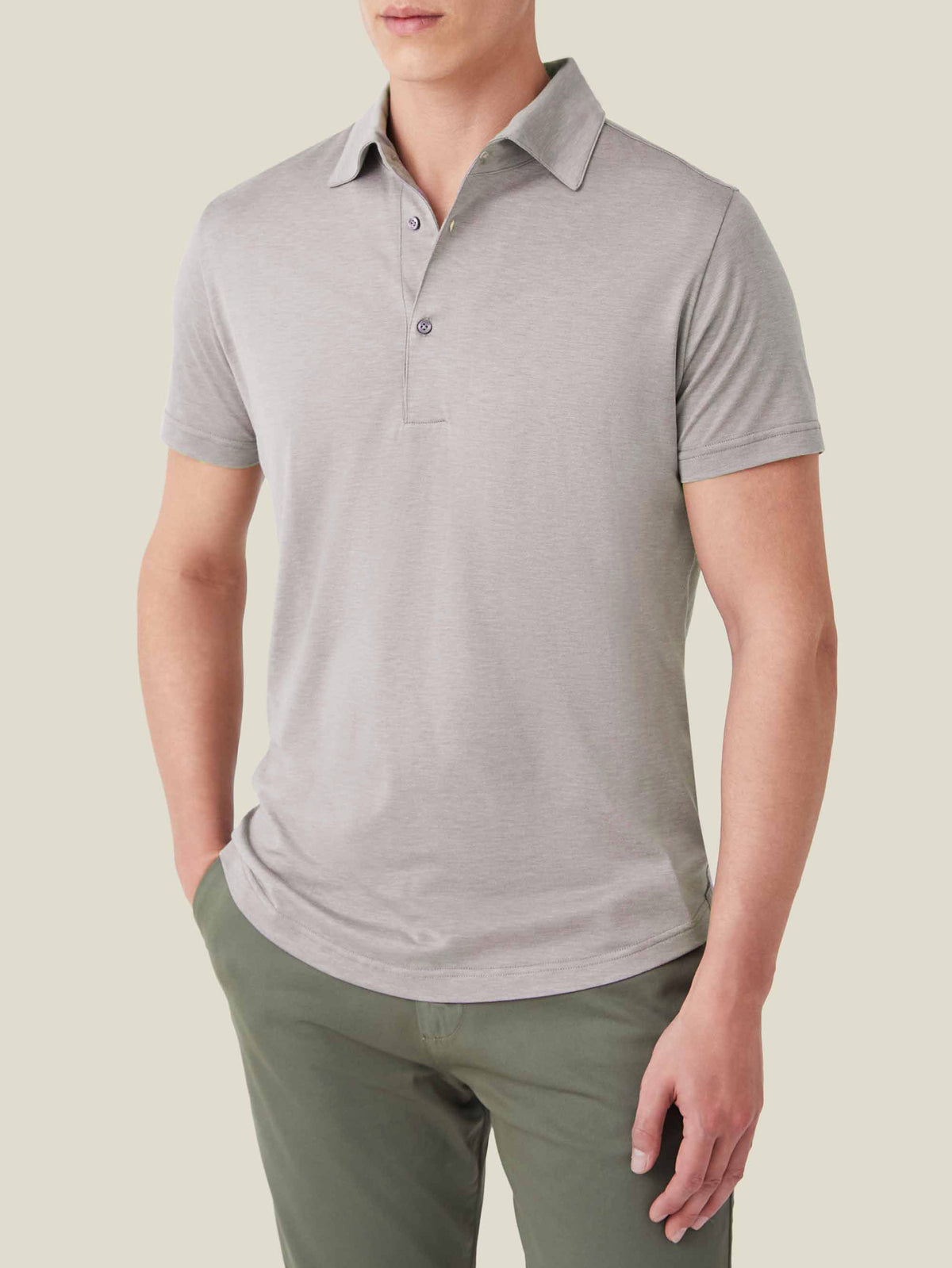 Model wears the Luca Faloni Short-Sleeved Silk-Cotton Polo in Nocciola Brown with green chinos.