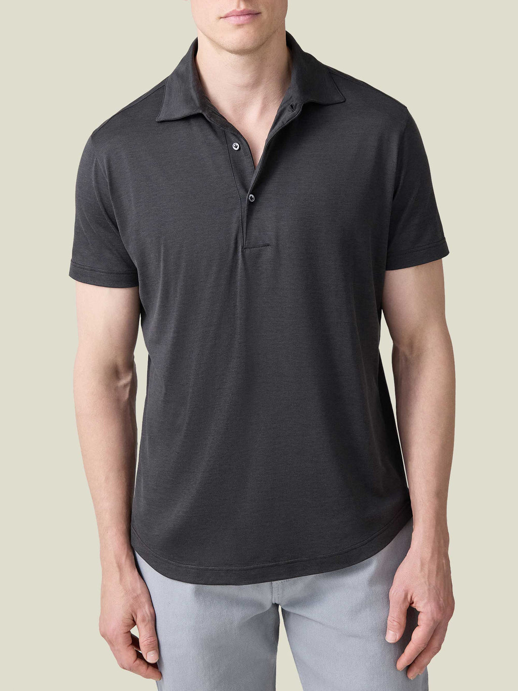 Front view of a man wearing a charcoal grey silk-cotton short-sleeved polo shirt by Luca Faloni.