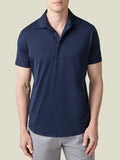 Front view of a man wearing the Luca Faloni Short-Sleeved Silk-Cotton Polo in Midnight Blue with light grey trousers.