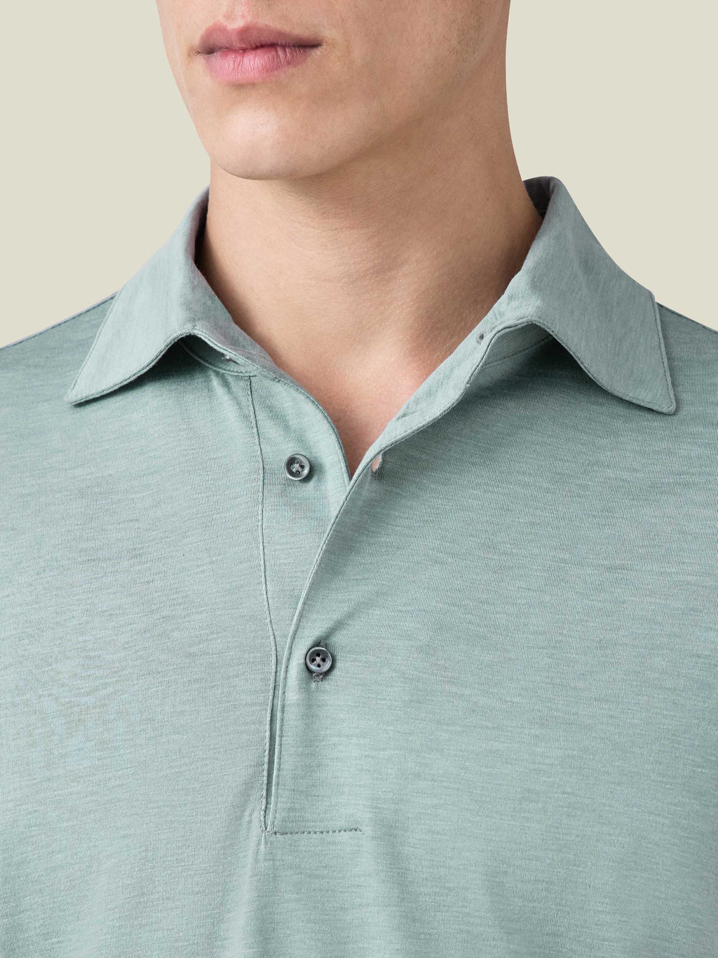 Close-up of the Marine Green Silk-Cotton Polo, detailing the one-piece collar, mother-of-pearl buttons and soft fabric.