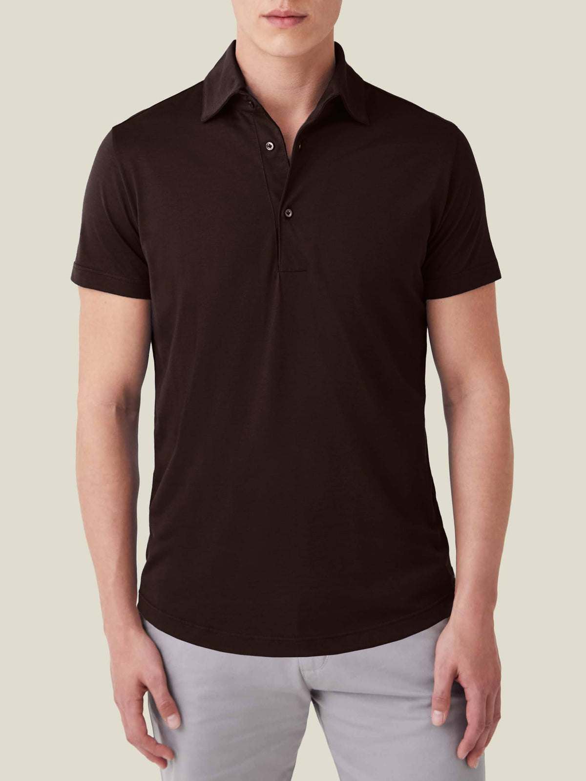 Front view of a model wearing the Luca Faloni Short-sleeved Silk Cotton Polo in chocolate brown against a plain background.