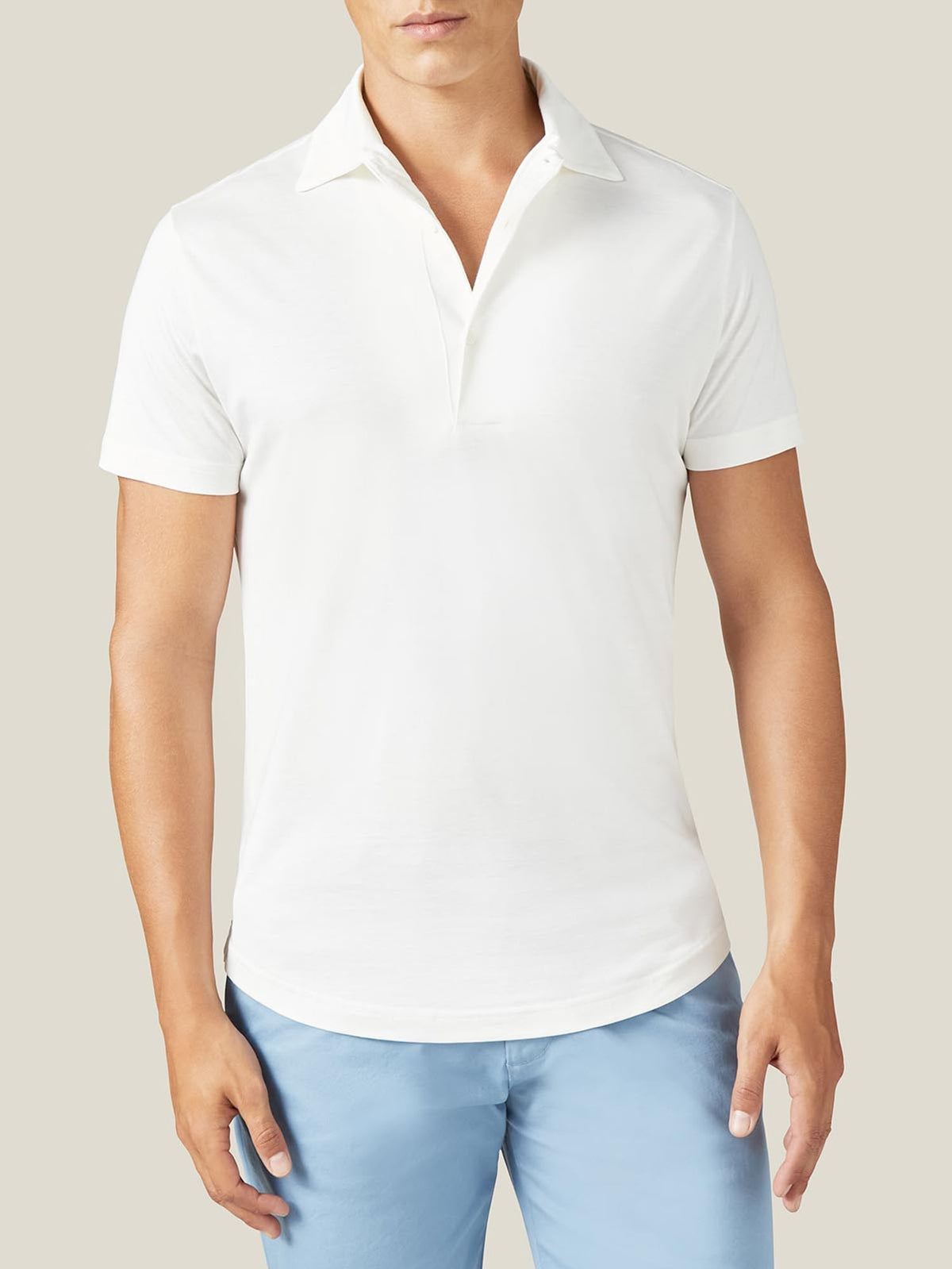 Front view of a man wearing the Luca Faloni white short-sleeved silk-cotton polo shirt.