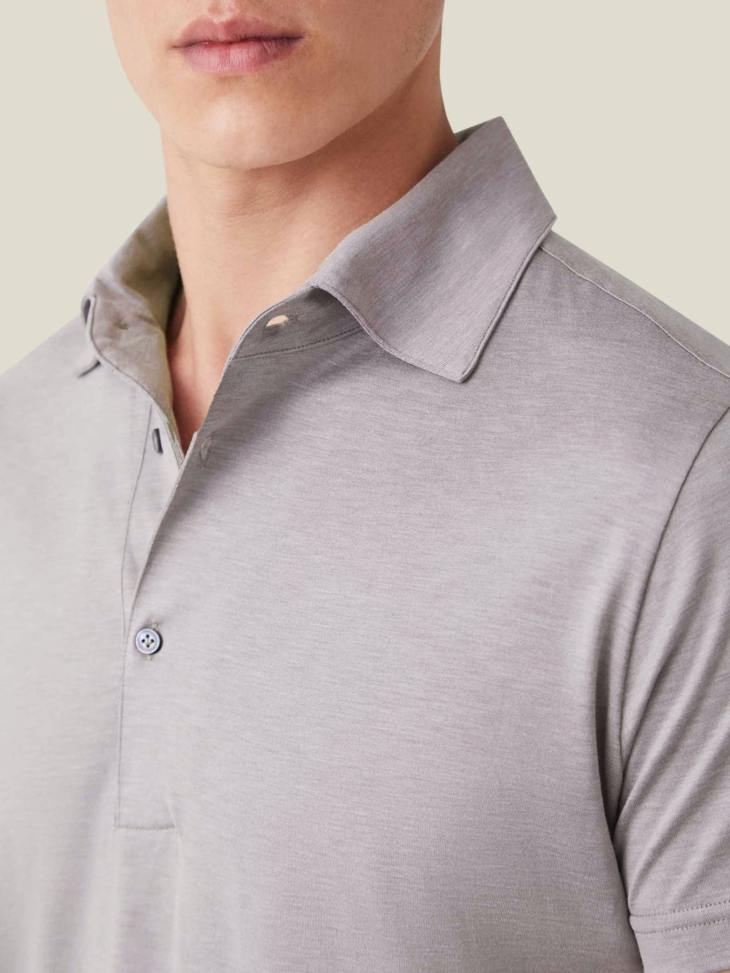 Close-up of a man wearing the Nocciola Brown Silk-Cotton Polo, showing the signature one-piece collar and fabric detail.