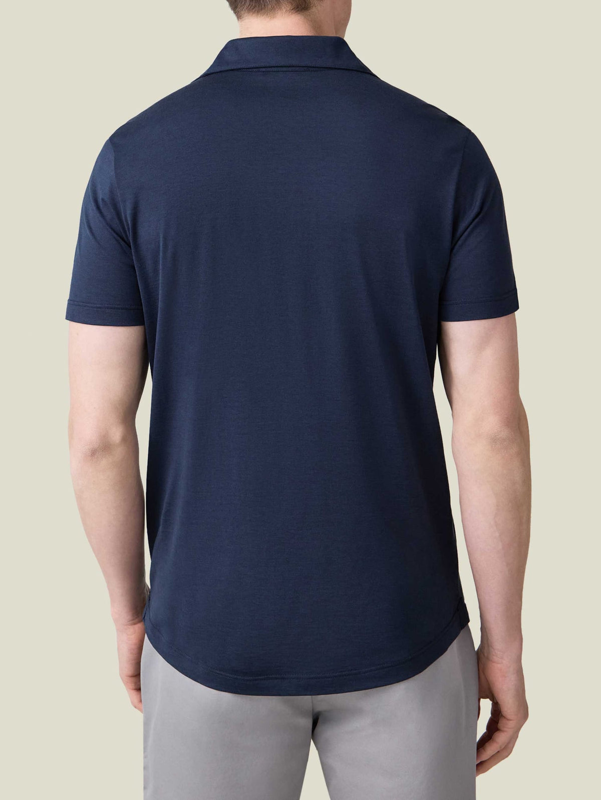 Back view of the Luca Faloni Short-sleeved Silk-Cotton Polo in midnight blue, showing its relaxed fit and rounded hemline.