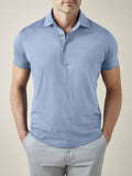 Front view of a model wearing the Luca Faloni Short-sleeved Silk Cotton Polo in light blue against a plain background.