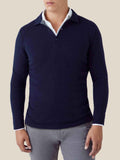 A man wears the Midnight Blue Cashmere Polo Sweater layered over a white shirt and paired with grey trousers.